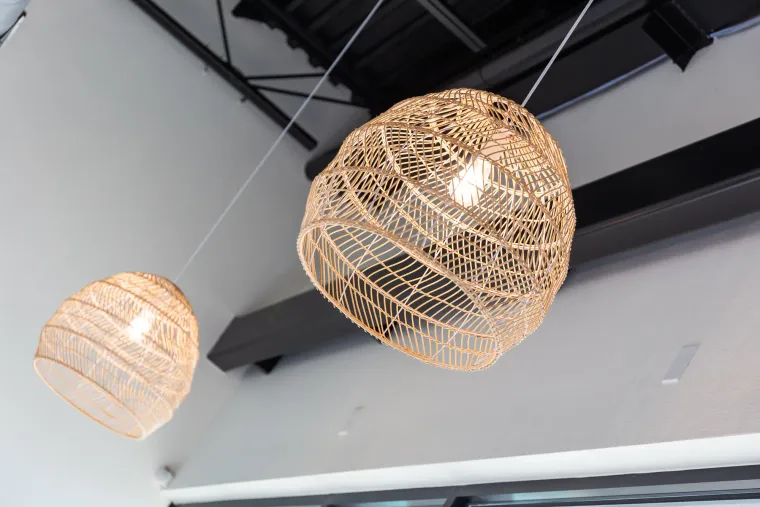 Woven rattan pendant lights hanging over the waiting room