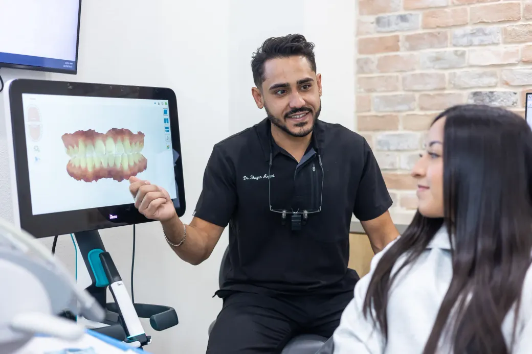 A patient reviewing her treatment plan on a chairside screen