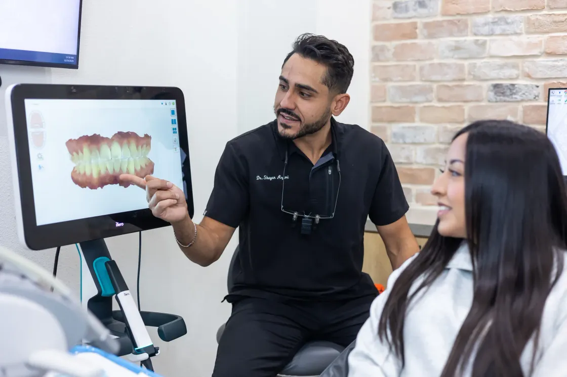 Dr. Shayan Azimi showing a patient her digital dental scan on a chairside screen at Arts Family Dentistry