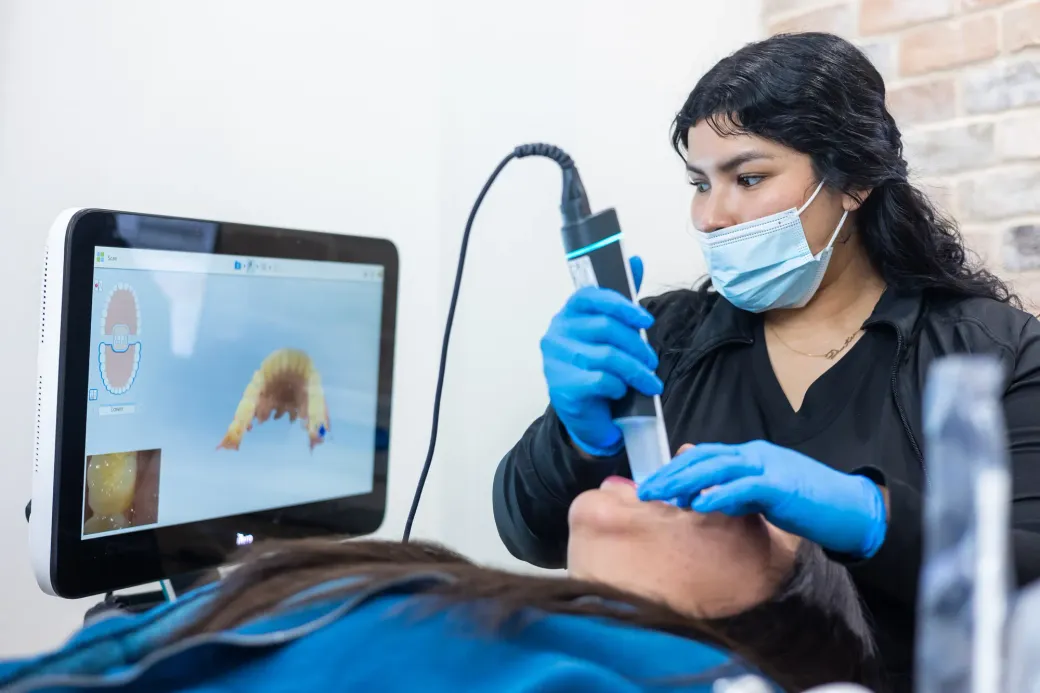 A hygienist using an iTero digital scanner to take orthodontic records