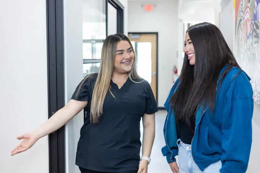 A team member welcoming a patient into the hallway at Arts Family Dentistry