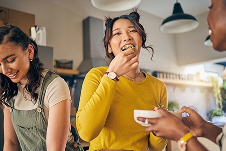Group of friends enjoying meal in kitchen