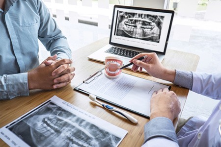 A man consulting with his dentist about implants