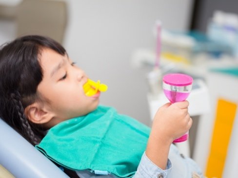 Child receiving fluoride treatment