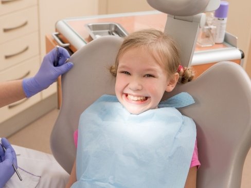 Young girl smiling after frenectomy