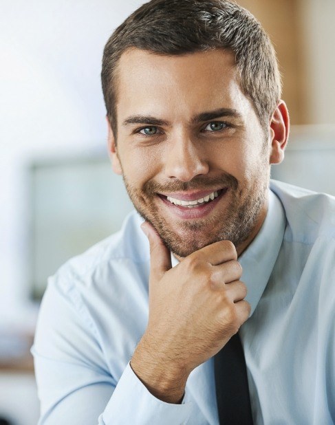 Man with healthy smile after dental crown restoration