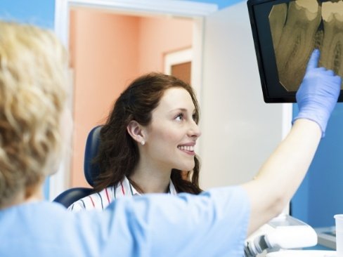 Dentist and patient discussing the process of getting a dental crown