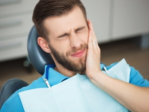 Man in pain before emergency dentistry