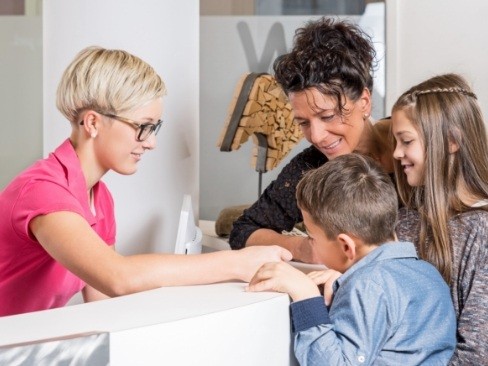 Mother and children checking in for emergency dentistry visit