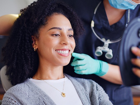 Happy cosmetic dentistry patient admiring her smile