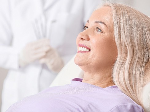 patient smiling while visiting dentist 