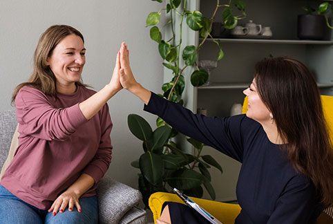 Team member giving dental patient a high five