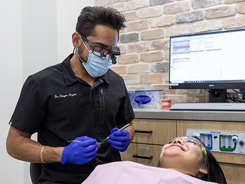 Woman talking to dentist about Invisalign