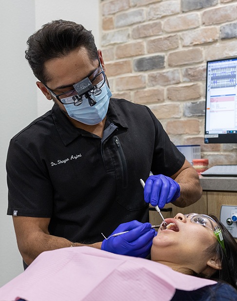 Smiling woman with toothbrush after preventive dentistry visit