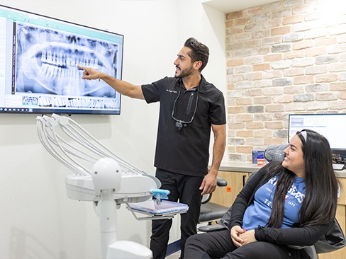 Woman giving two thumbs up after dental checkups and teeth cleanings