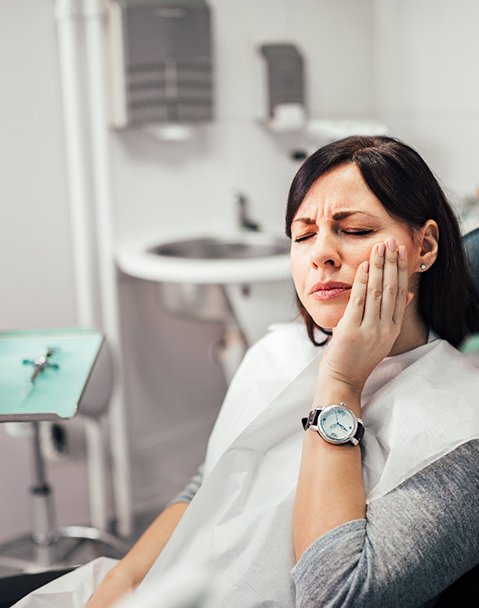 Woman with toothache at dentist's office