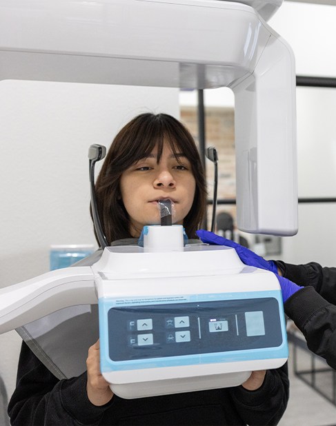 Smiling team member in state of the art dental office building