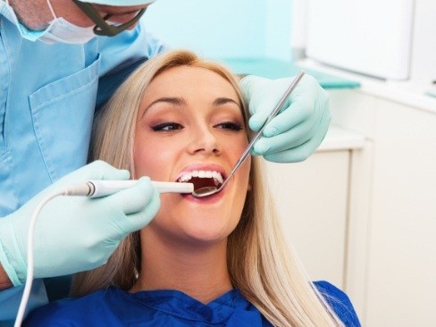 Dentist using intraoral camera to capture smile images