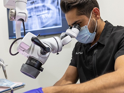 Dentist and patient looking at digital dental x-rays