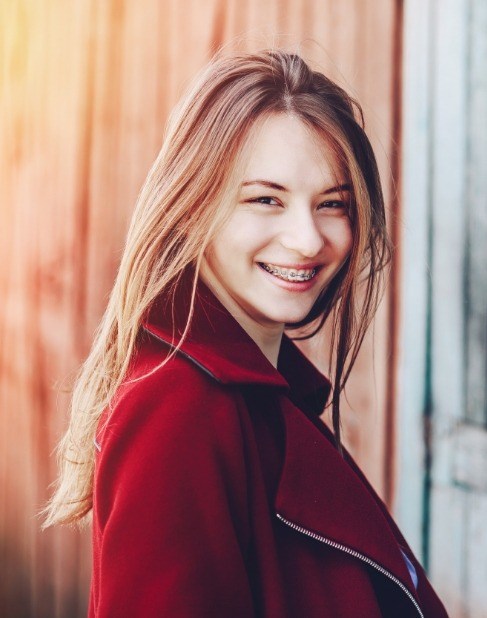 Smiling teen with traditional orthodontics