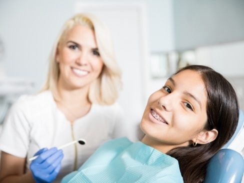 Teen with traditional braces at the dental office