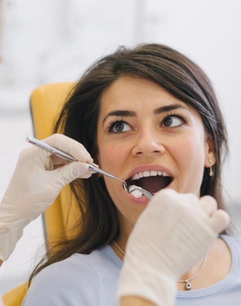 Woman receiving wisdom tooth extraction